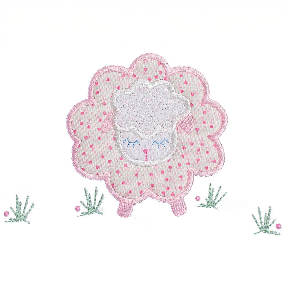 close-up of a hand made applique of a pink floral sheep with darling pink ears and feet