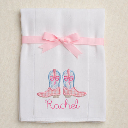 Detail of the pink check/blue toile cowboy boots applique and personalized embroidered name on the cloth diaper burp pad.  Burp pad is folded and tied with a grosgrain ribbon for gift giving.
