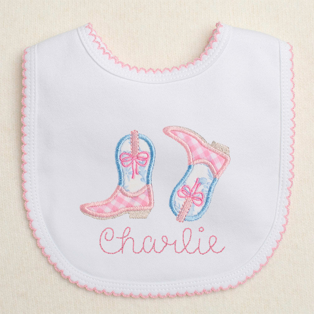 Baby bib with appliqued pink cowboy boots and personalized with a custom name for a truly one of a kind gift.