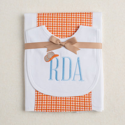 2 piece baby gift set with a monogrammed bib and a fabric burp pad.