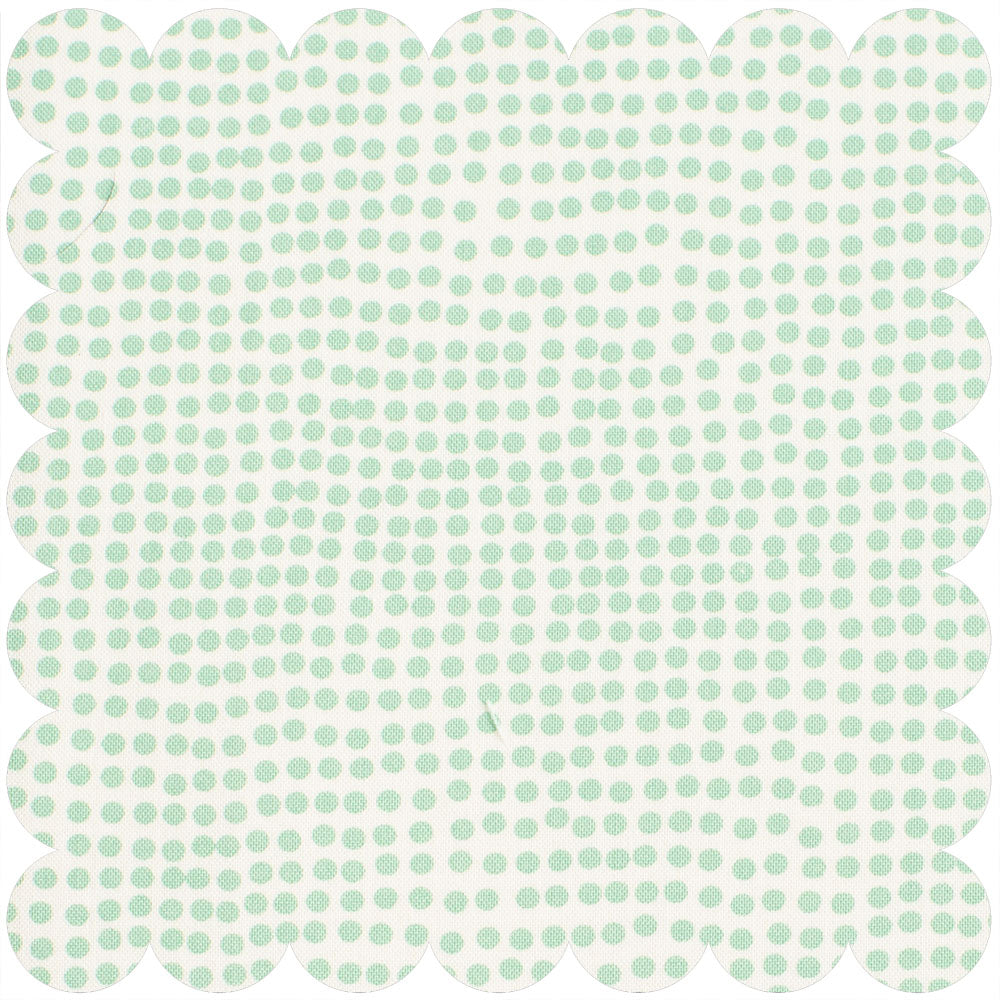 Cream ground with irregular shaped green polka dots