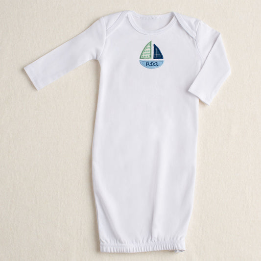 White cotton baby gown with zipper closure with embroidered sailboat and personalized name for specialty gift giving.