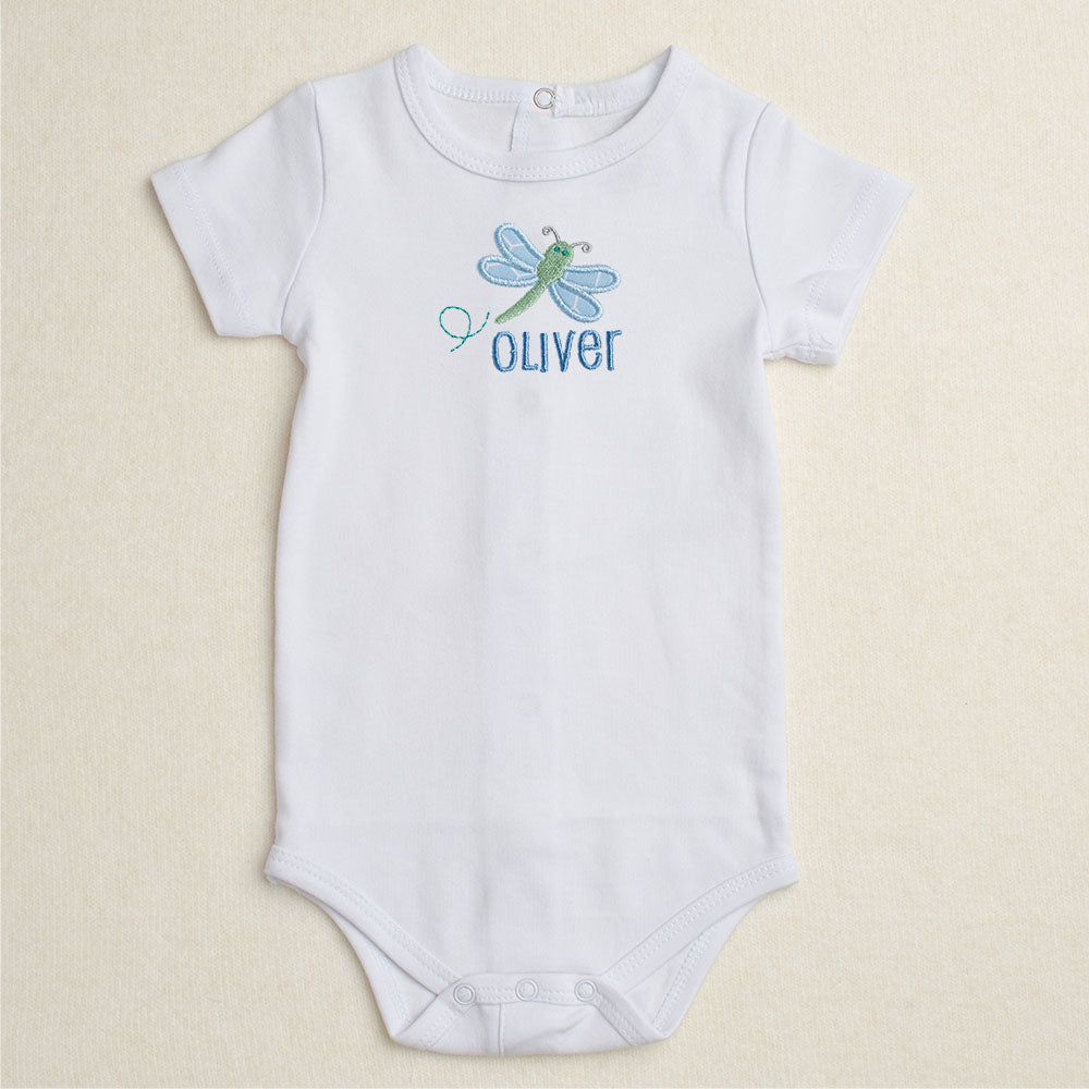 All cotton bodysuit with short sleeves and a blue dragonfly applique that can be personalized with embroidery