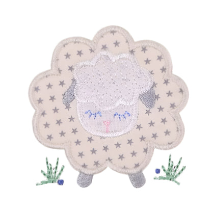 close up of Deacon Lane signature gender neutral grey sheep applique design in grey, cream, and white