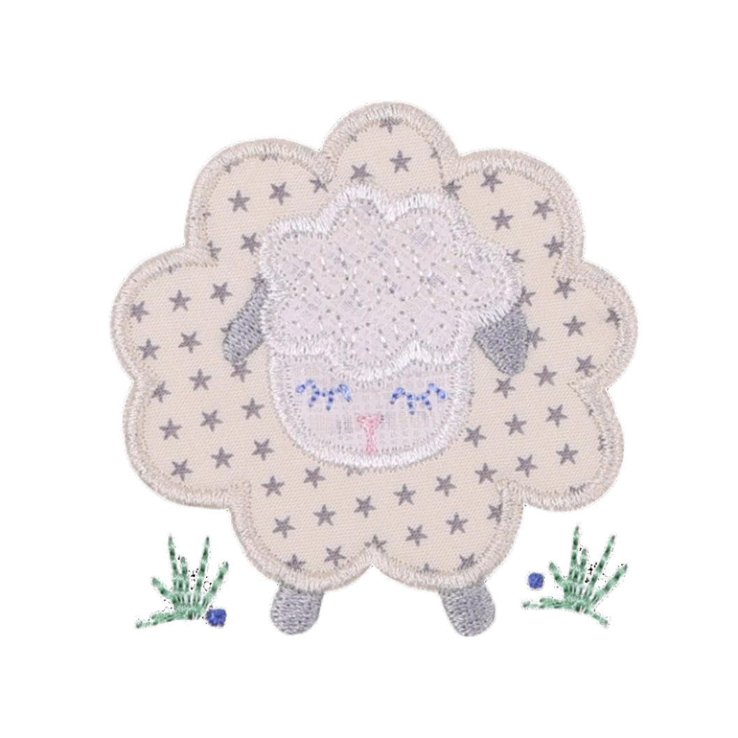 close up picture of Deacon Lane's Fluffy Grey Sheep Applique in shades of cream, grey, and white