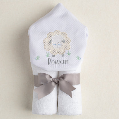 perfect personalized baby gift is a hooded towel with a grey sheep applique and an embroidered personalized name.  Rolled and tied with a grey grosgrain ribbon.