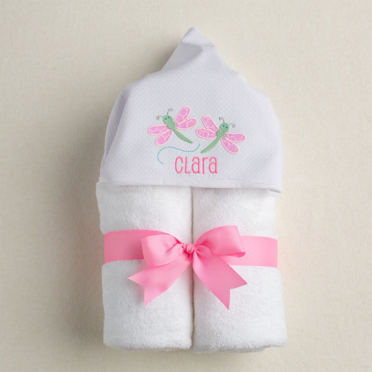 White hooded towel with pique hood and 2 pink and green dragonfly appliques for Deacon Lane.  Personalized with an embroidered name.