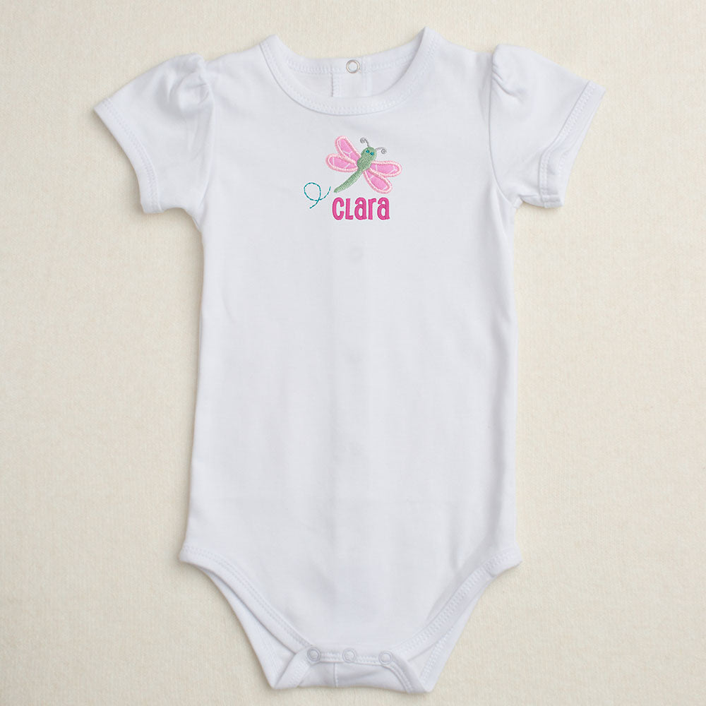 All cotton bodysuit with puff sleeves and a pinkdragonfly applique that can be personalized with embroidery