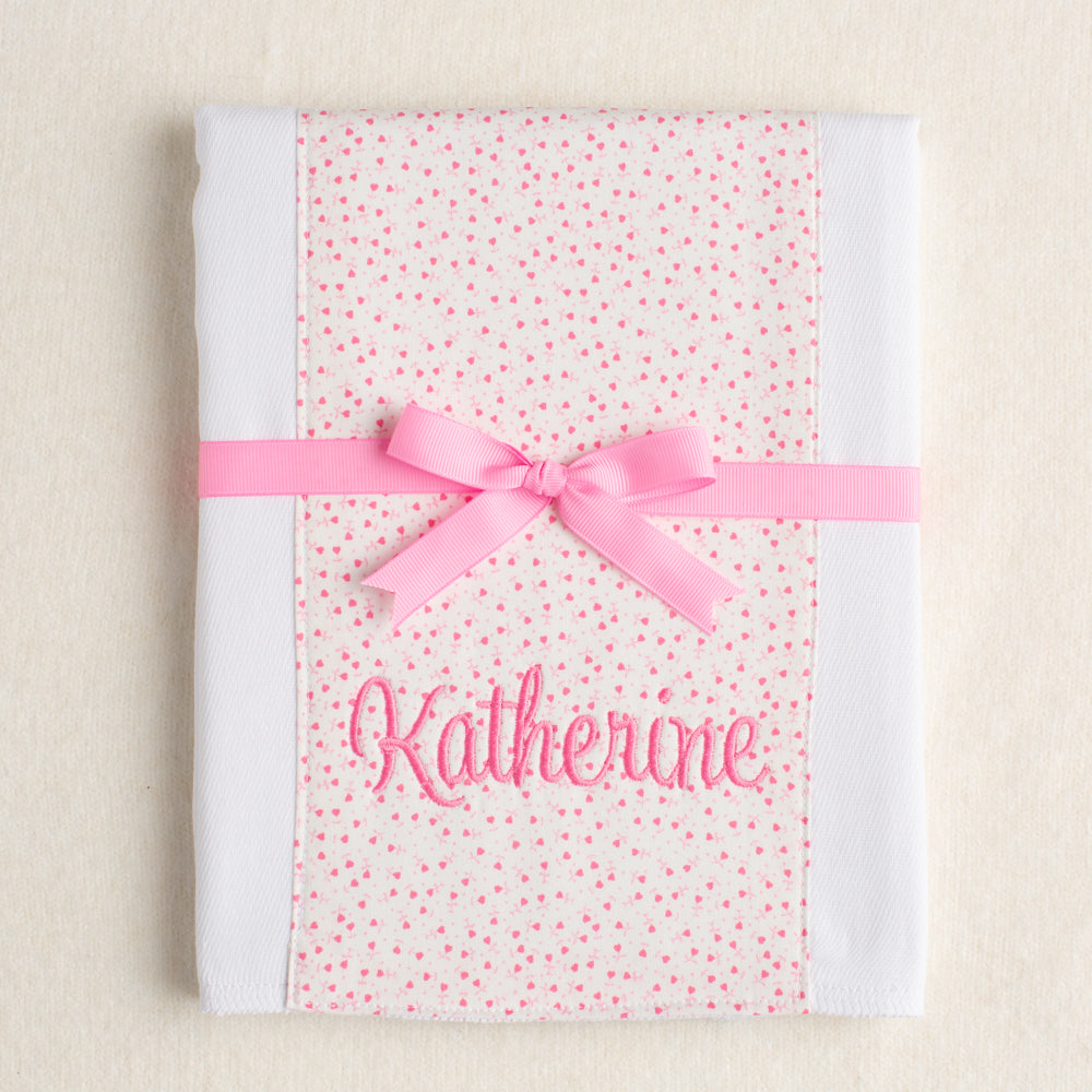 personalized burp pad with pink floral panel of fabric sewn down the middle.  Boutique gift personalized with an embroidered name