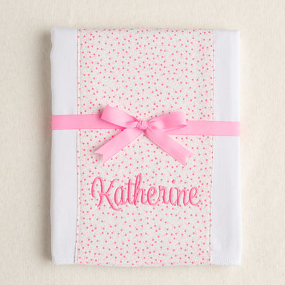 personalized burp pad with pink floral panel of fabric sewn down the middle.  Boutique gift personalized with an embroidered name