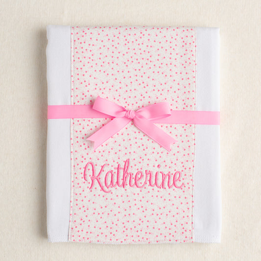 personalized burp pad with pink floral panel of fabric sewn down the middle.  Boutique gift personalized with an embroidered name