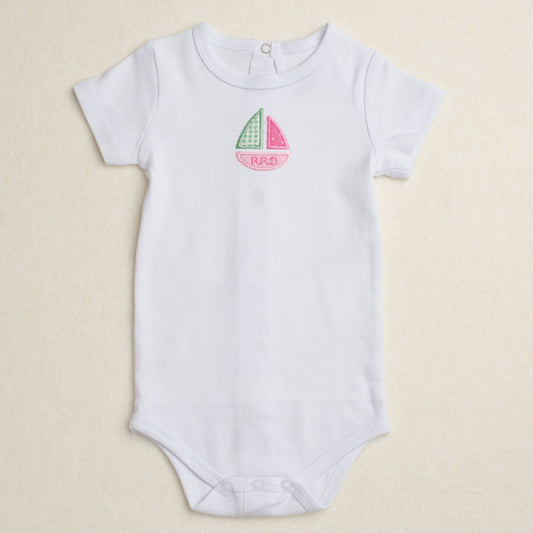 All cotton bodysuit with puff sleeves and a pink sailboat applique that can be personalized with embroidery